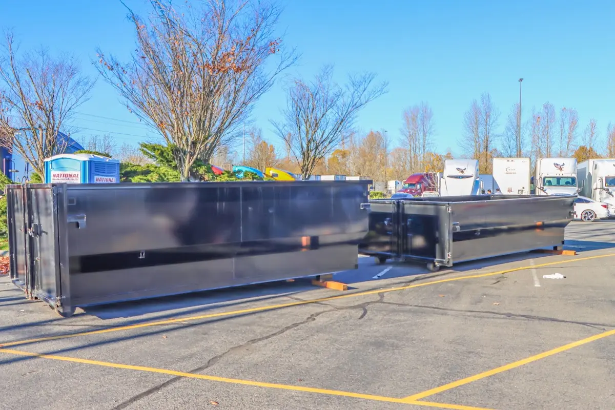 Professional dumpster rental service with roll-off container on residential driveway in Little Egg Harbor